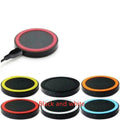 Square Qi wireless phone charger base in six colour options on a wooden desk.