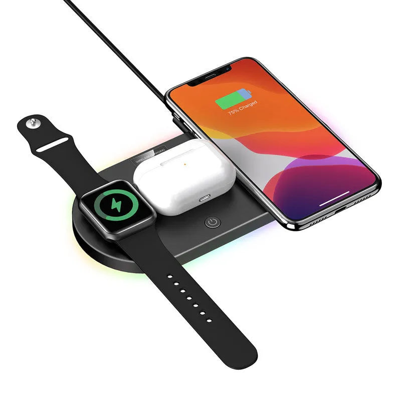 Black circular 15W wireless charging pad with USB port on desk next to phone