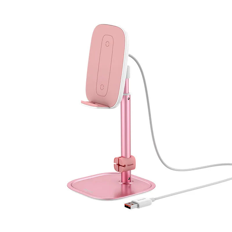 Baseus 15W wireless charger stand with adjustable tablet holder in silver, holding a smartphone on a desktop