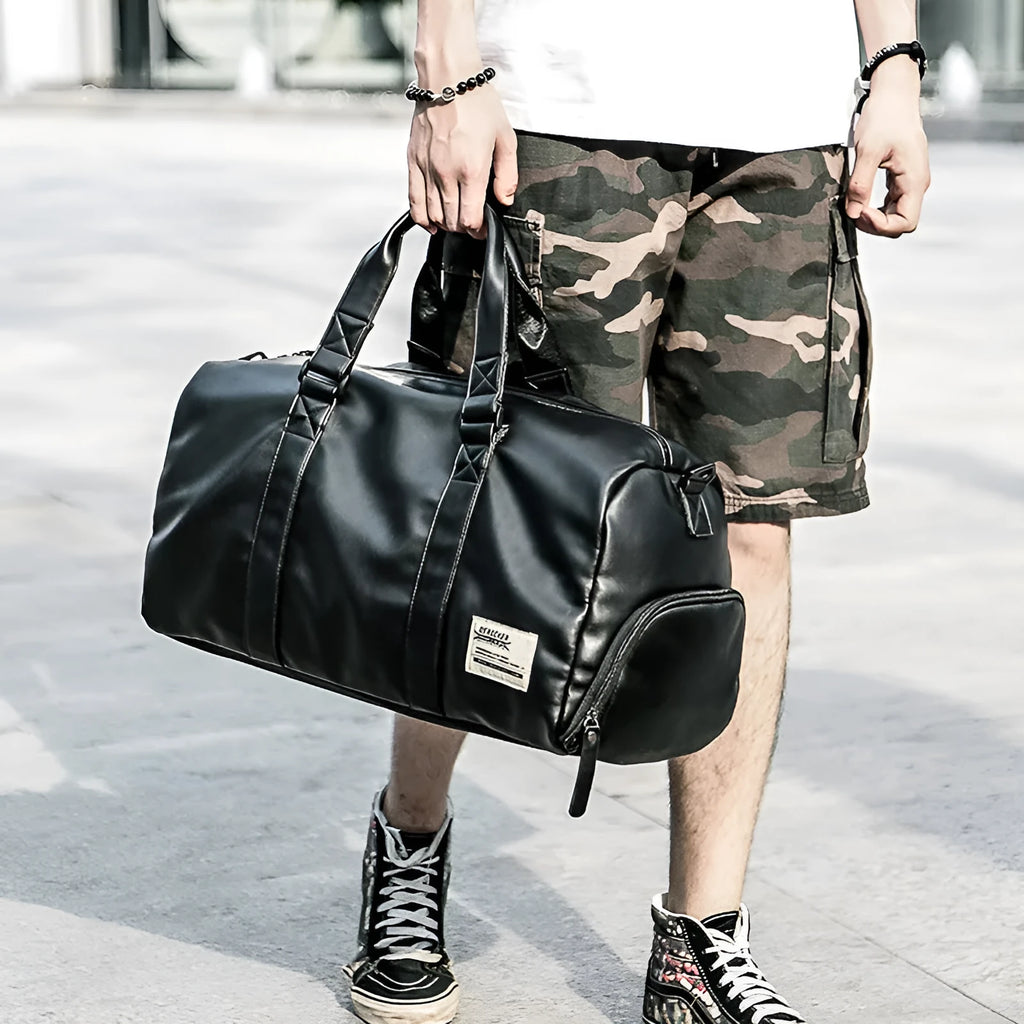 Large black waterproof PU leather sports training bag with shoulder strap and multiple internal pockets.