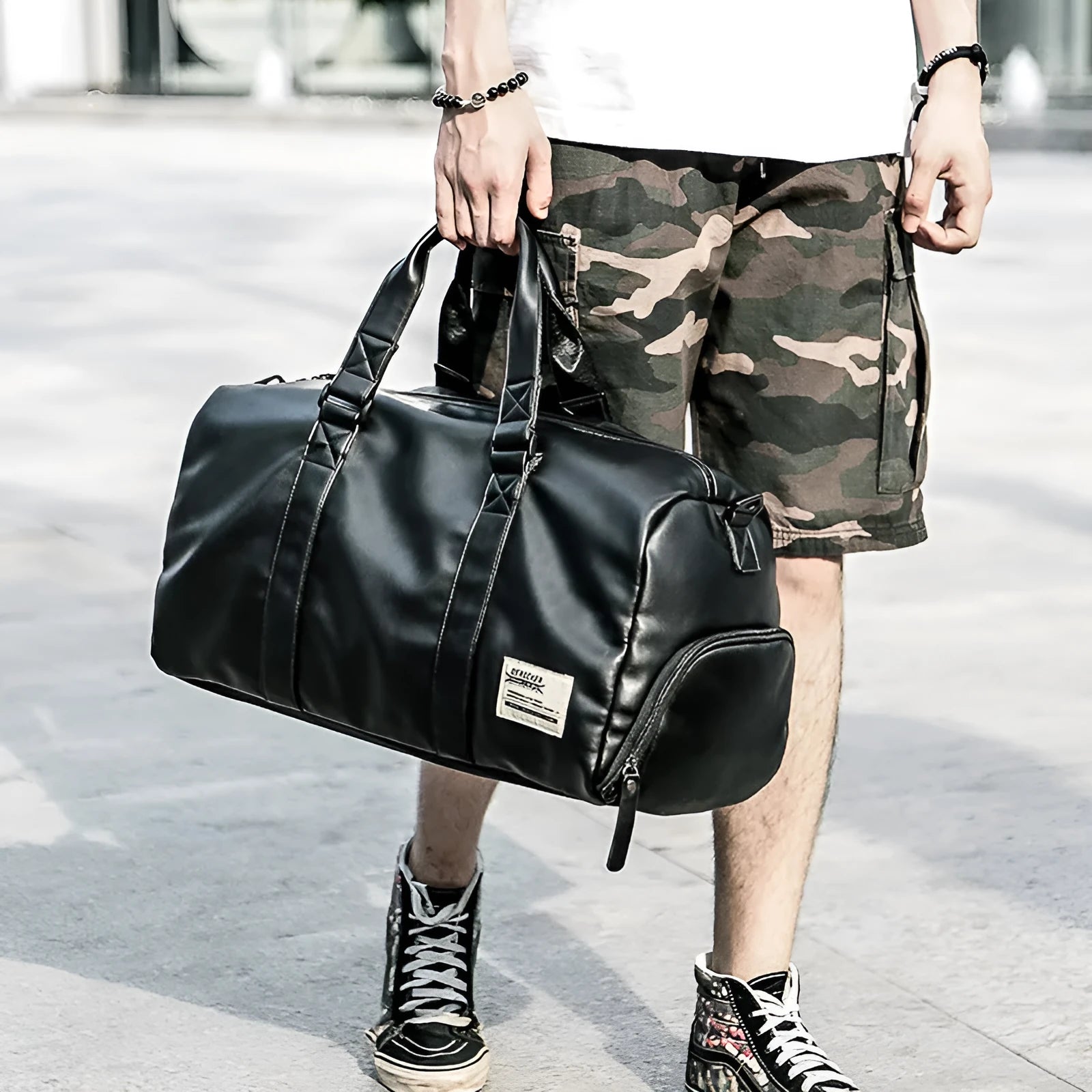 Large black waterproof PU leather sports training bag with shoulder strap and multiple internal pockets.