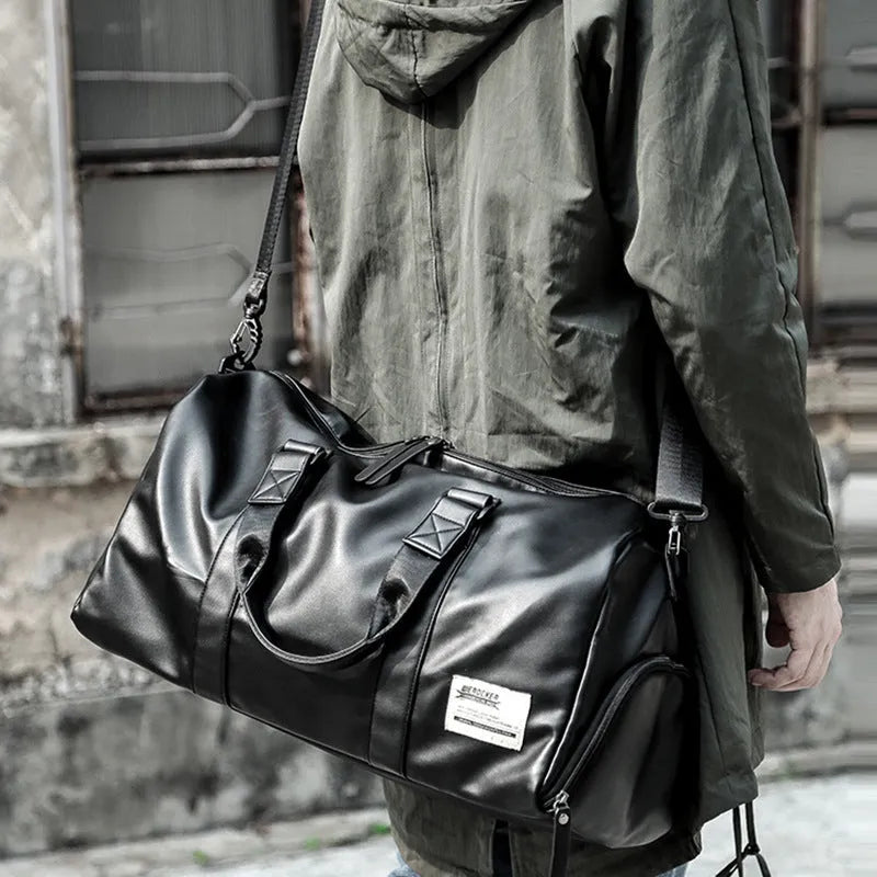 Large black waterproof PU leather sports training bag with shoulder strap and multiple internal pockets.