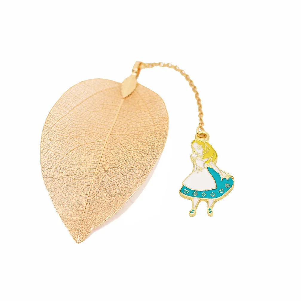 KC alloy bookmark charms showing Alice, Rabbit, Clock, and Leaf designs on kraft cardboard packaging