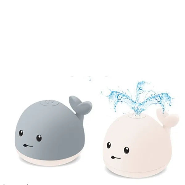 Grey and white cartoon whale bath toy floating in water with spray fountain and LED lights