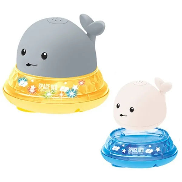 Grey and white cartoon whale bath toy floating in water with spray fountain and LED lights