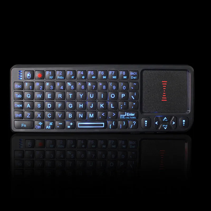 Black wireless mini keyboard with touch screen and matching laser mouse on a desk.