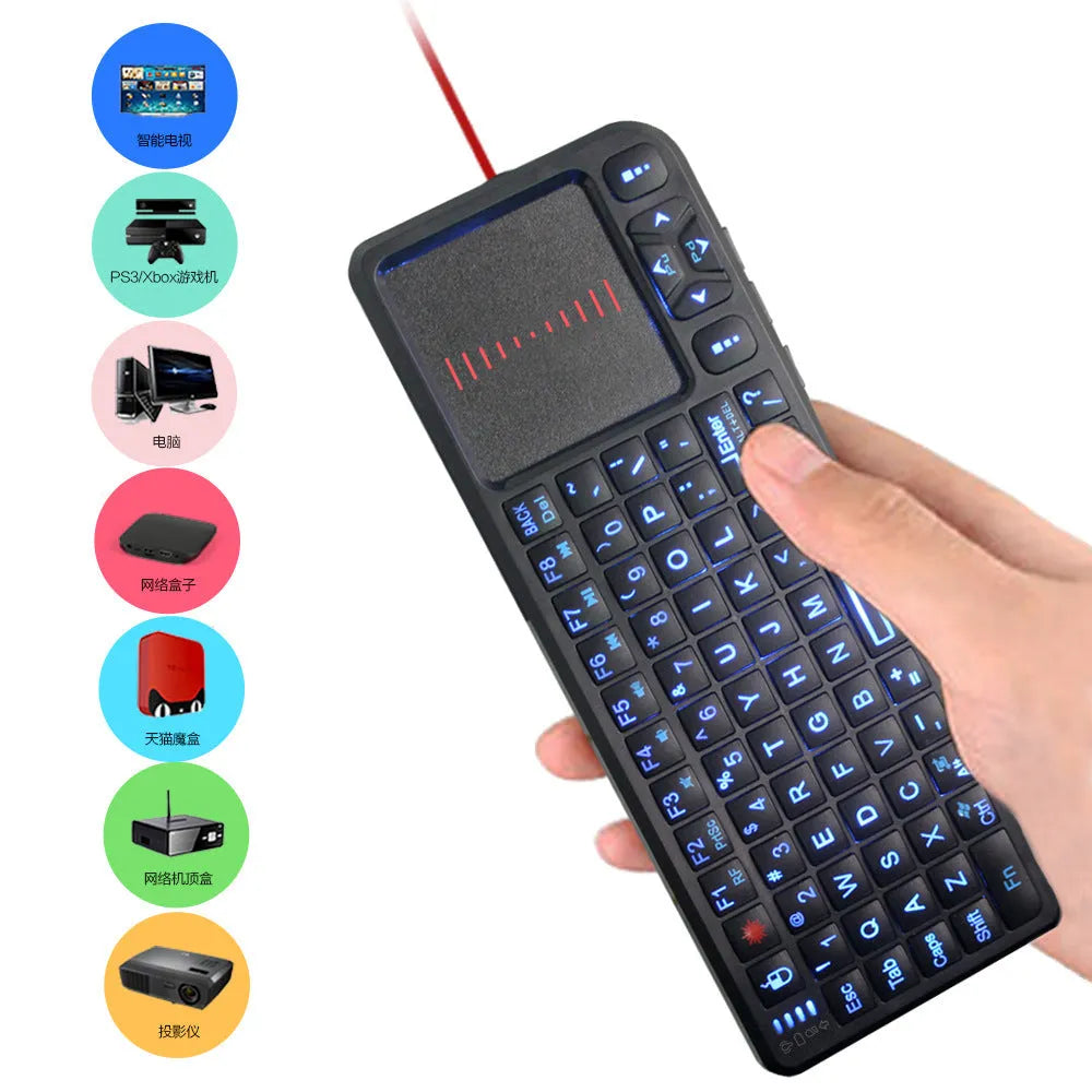 Black wireless mini keyboard with touch screen and matching laser mouse on a desk.