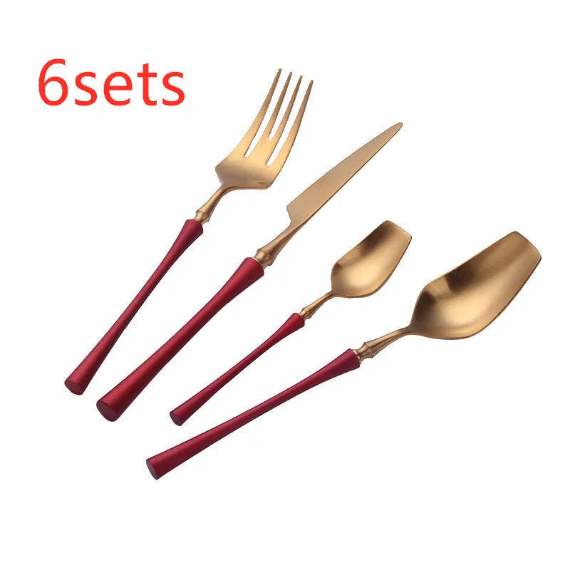 Stainless steel cutlery set with gold finish including knife, fork, spoon, and teaspoon on table