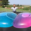 Large pink, yellow, green, and blue inflatable TPR bouncy balls in different sizes.