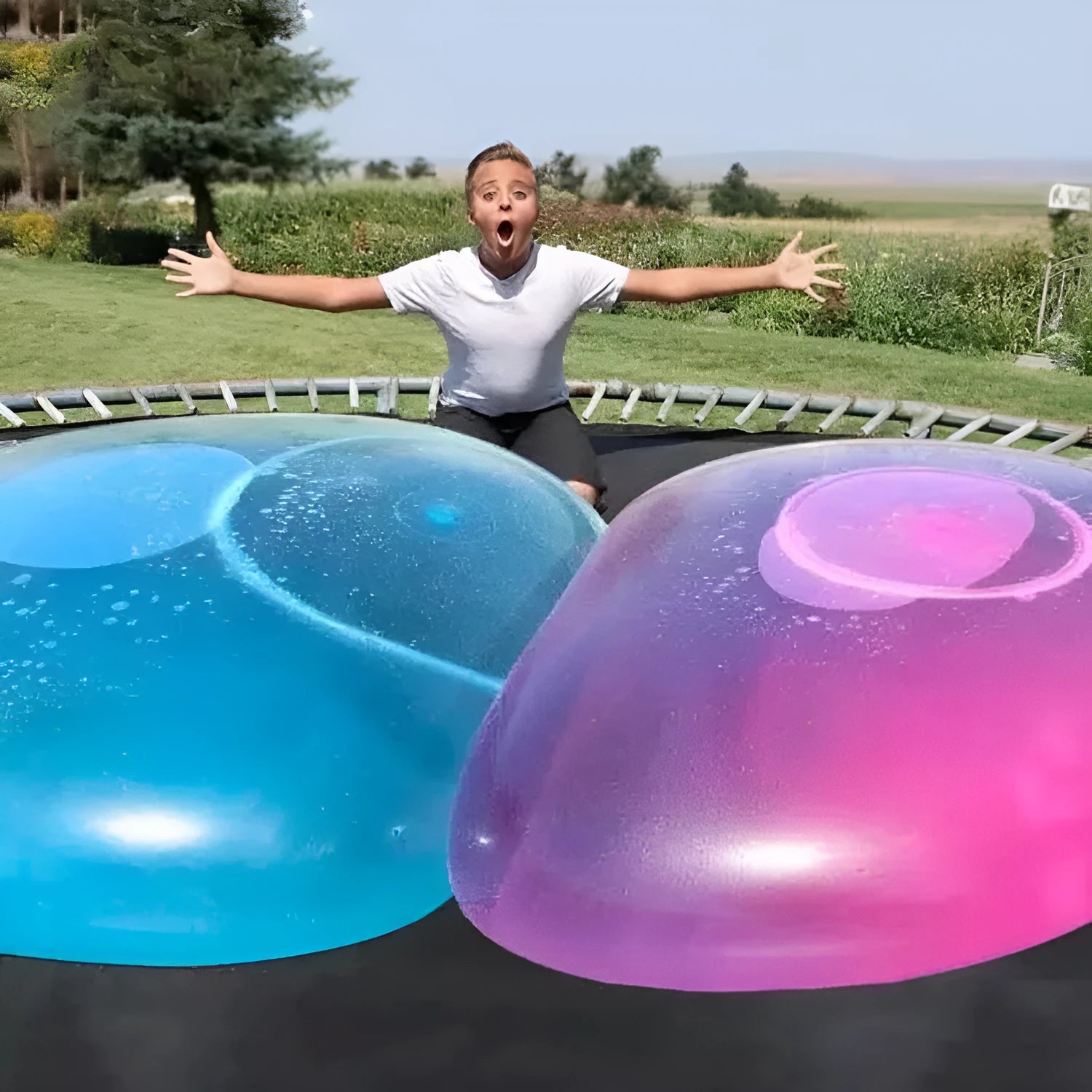 Large pink, yellow, green, and blue inflatable TPR bouncy balls in different sizes.