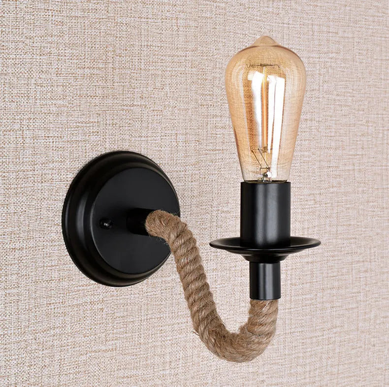 Retro creative wrought iron twine wall lamp in black with handmade hemp rope wrap on a bedside table
