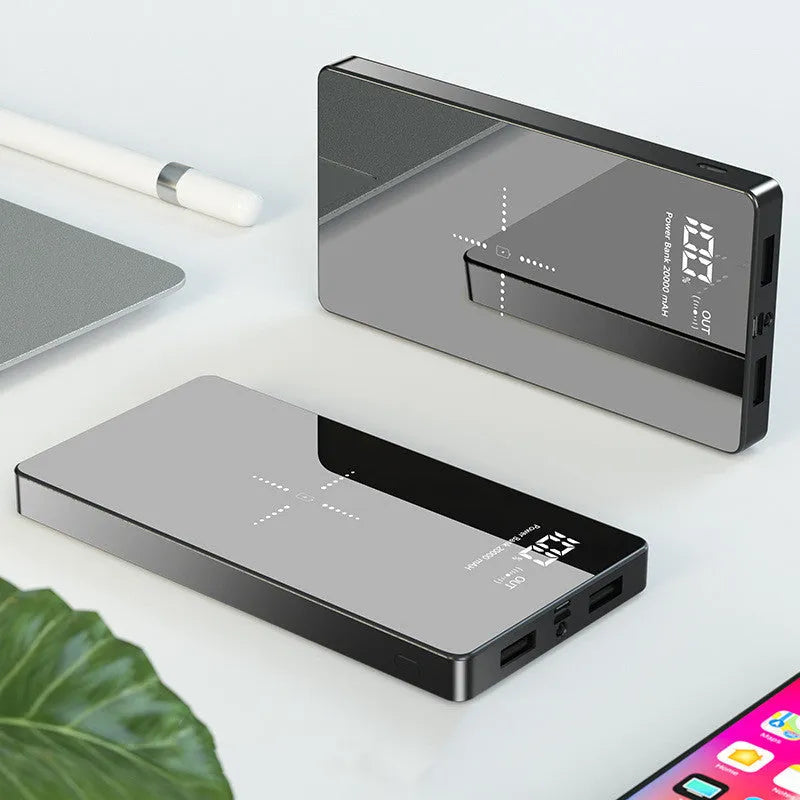 Black wireless power bank with digital display showing battery percentage, featuring a mirror finish and two USB ports.