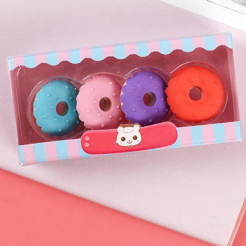 Assortment of 12 colourful cartoon food shaped pencil erasers including ice cream cones, donuts, and lollipops.
