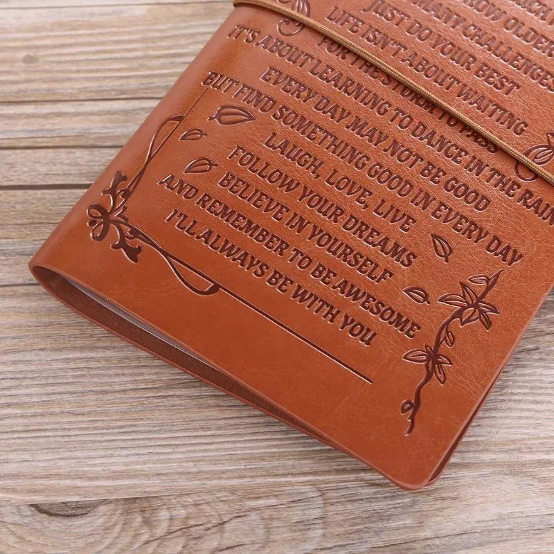 Brown leather hand ledger business notebook with strap binding closed