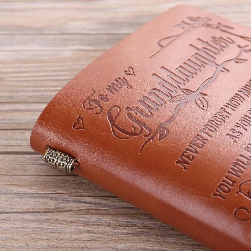 Brown leather hand ledger business notebook with strap binding closed
