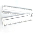 White plastic multi-function ruler measuring 30 cm in length on a flat surface.