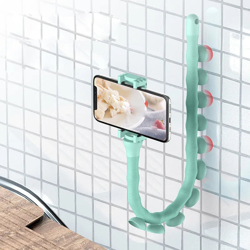 Black flexible rubber phone holder with suction cup base bent into an arc shape