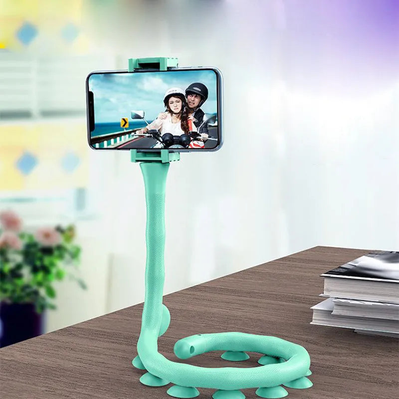 Black flexible rubber phone holder with suction cup base bent into an arc shape