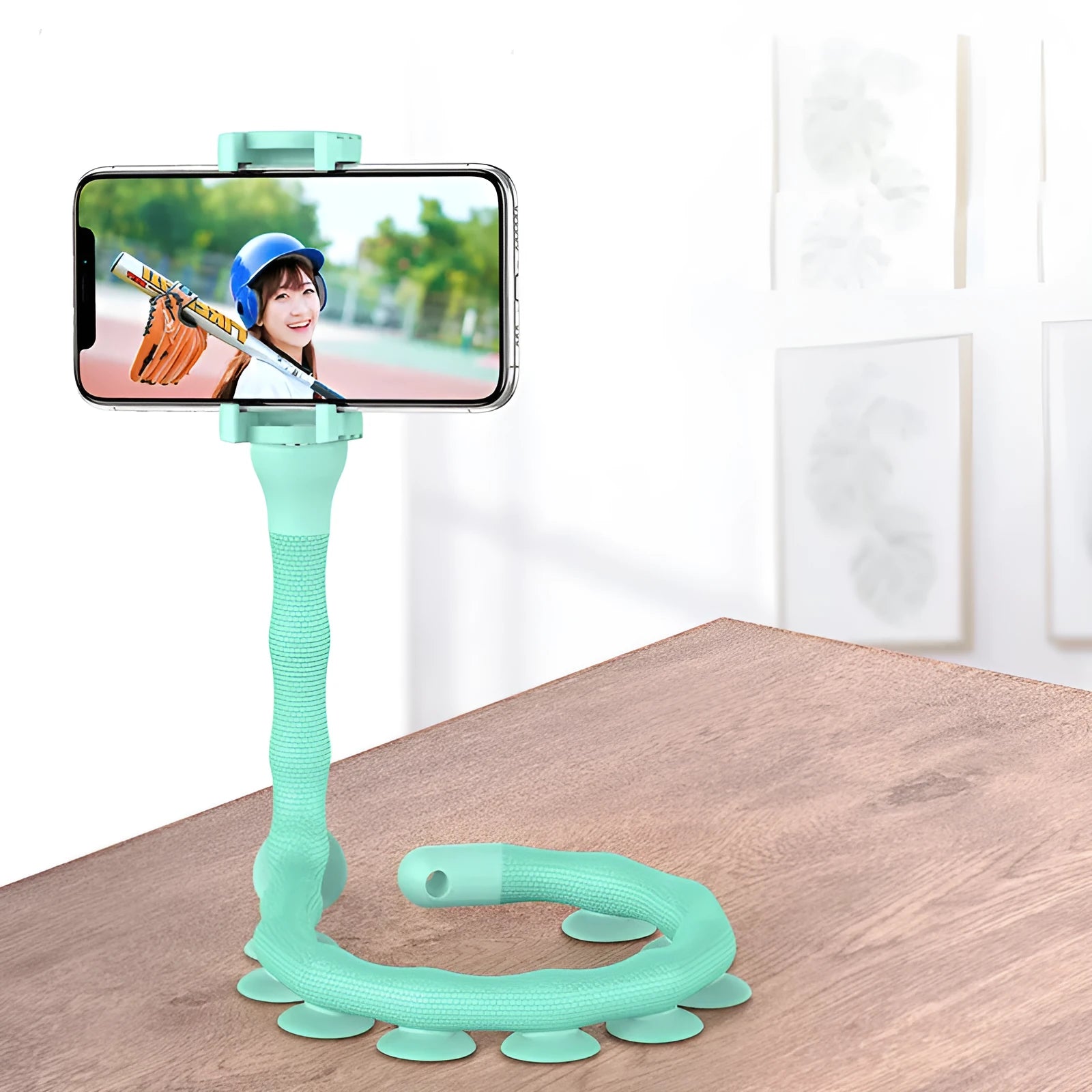 Black flexible rubber phone holder with suction cup base bent into an arc shape