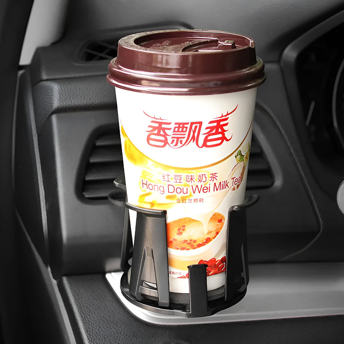 Black ABS car air outlet beverage holder attached to a vehicle air vent showing drink storage