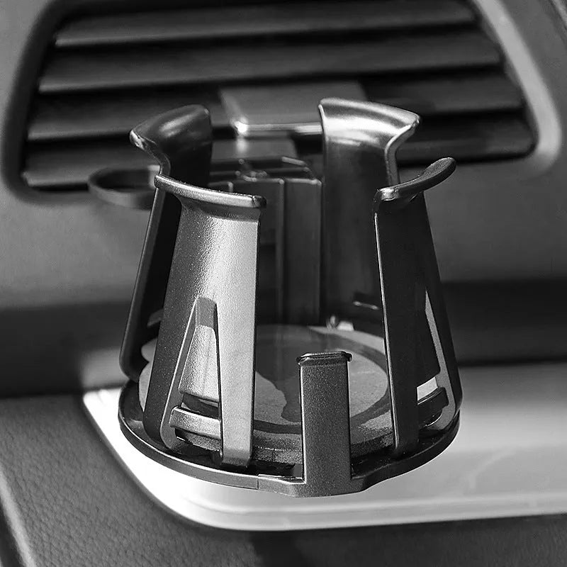 Black ABS car air outlet beverage holder attached to a vehicle air vent showing drink storage