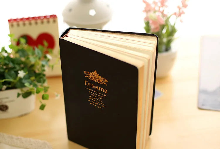 Jingu 35mm thick imitation leather notebook open on a desk.