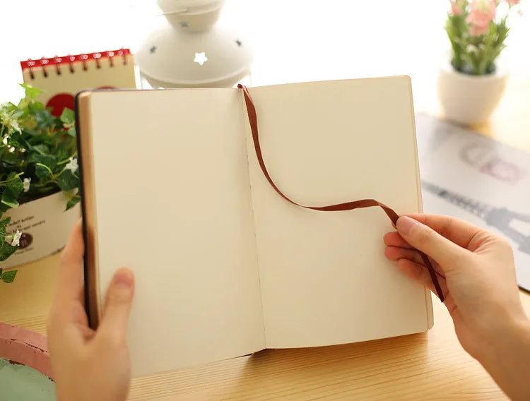 Jingu 35mm thick imitation leather notebook open on a desk.