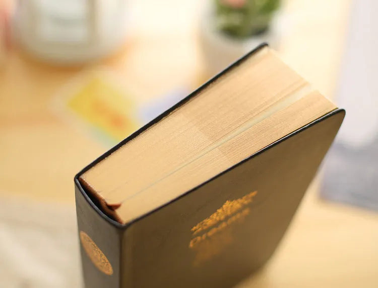 Jingu 35mm thick imitation leather notebook open on a desk.