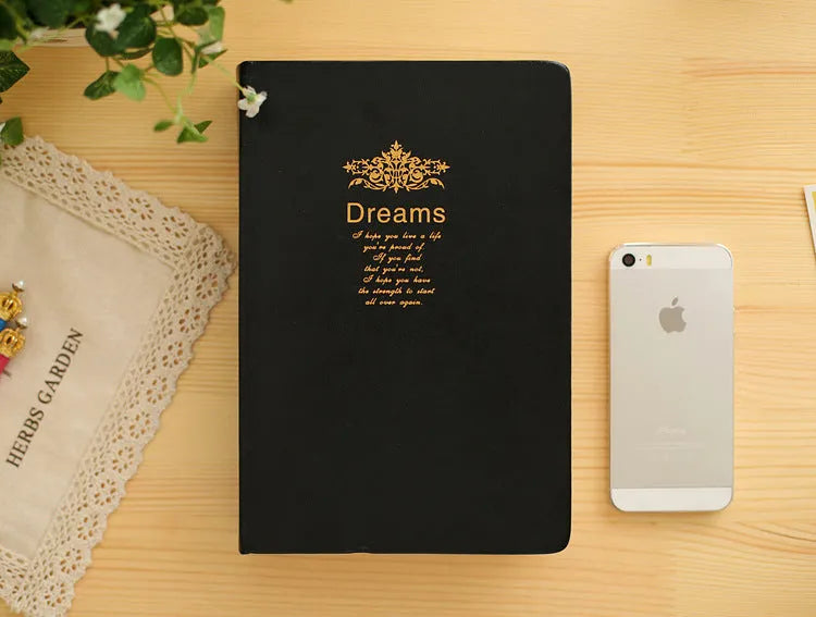 Jingu 35mm thick imitation leather notebook open on a desk.