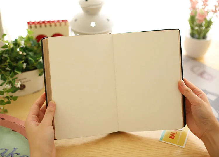 Jingu 35mm thick imitation leather notebook open on a desk.