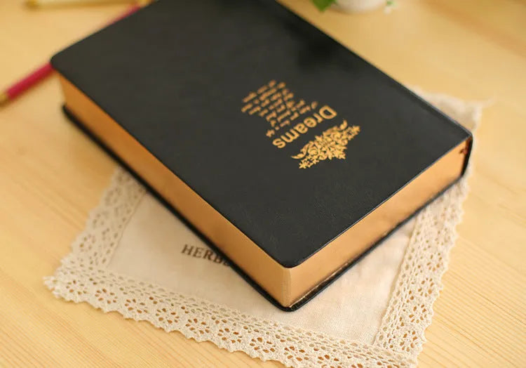 Jingu 35mm thick imitation leather notebook open on a desk.