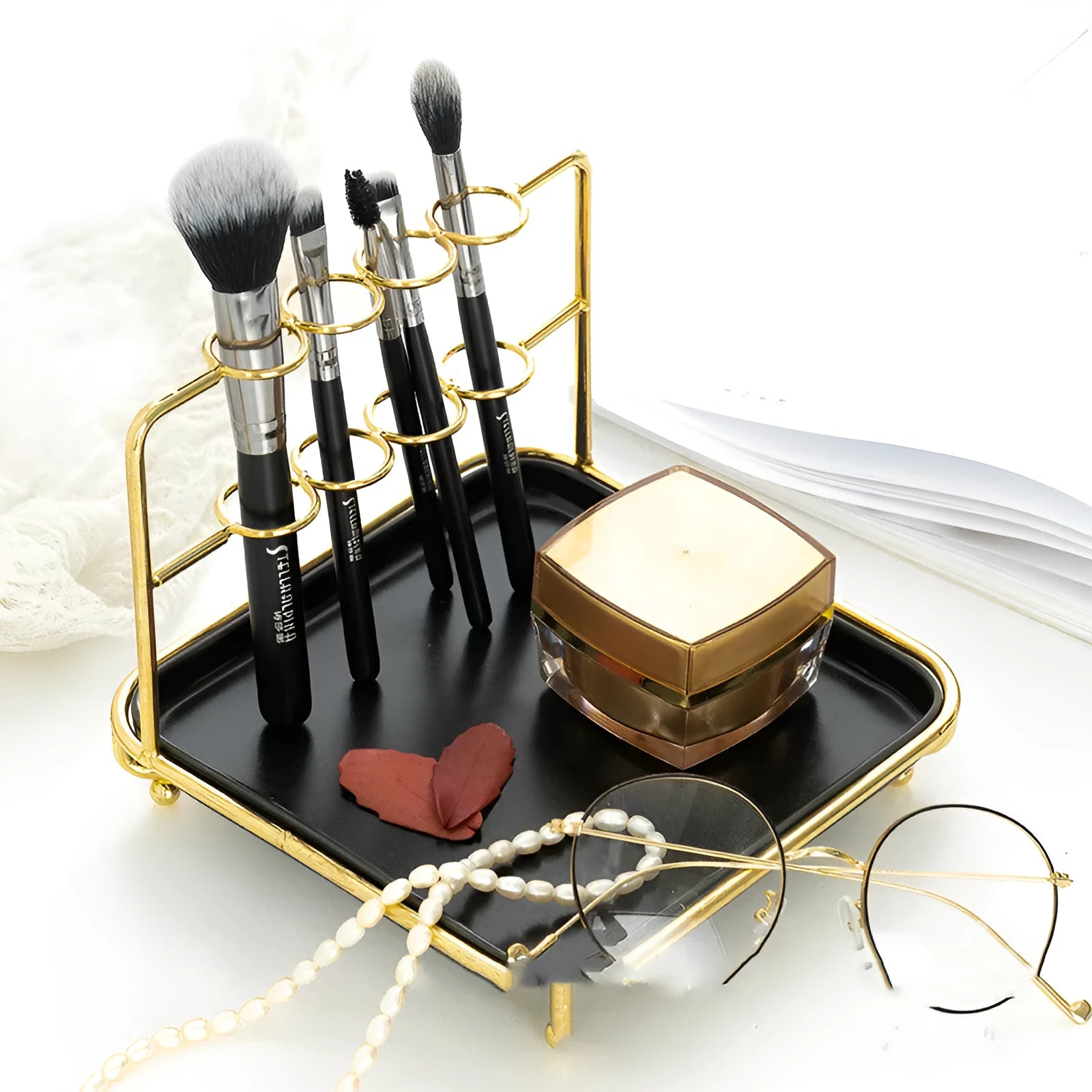 Modern cosmetics storage rack in iron and ceramic on a desktop with makeup items inside