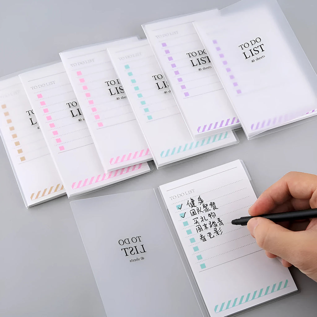 Green PP frosted A6 notebook with tearable pages, shown next to a pen, measuring 13 by 8 cm.
