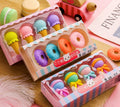 Assortment of 12 colourful cartoon food shaped pencil erasers including ice cream cones, donuts, and lollipops.