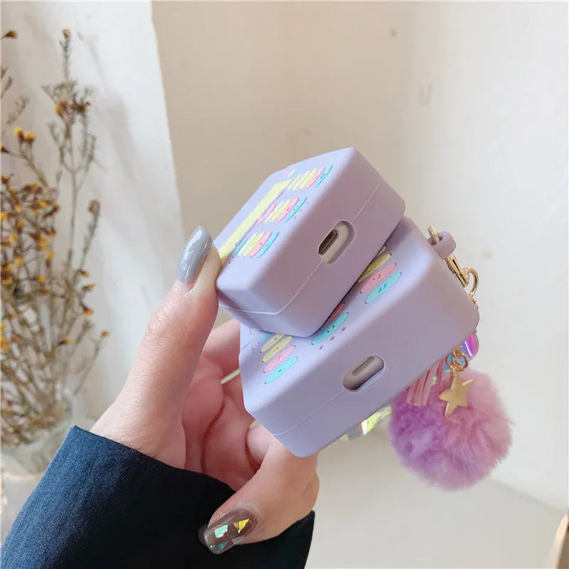 Purple silicone Apple AirPods protective case with fur ball pendant, clamshell design