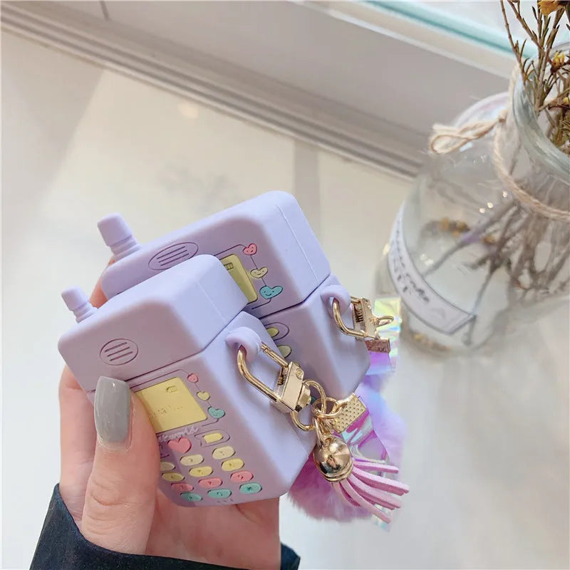 Purple silicone Apple AirPods protective case with fur ball pendant, clamshell design