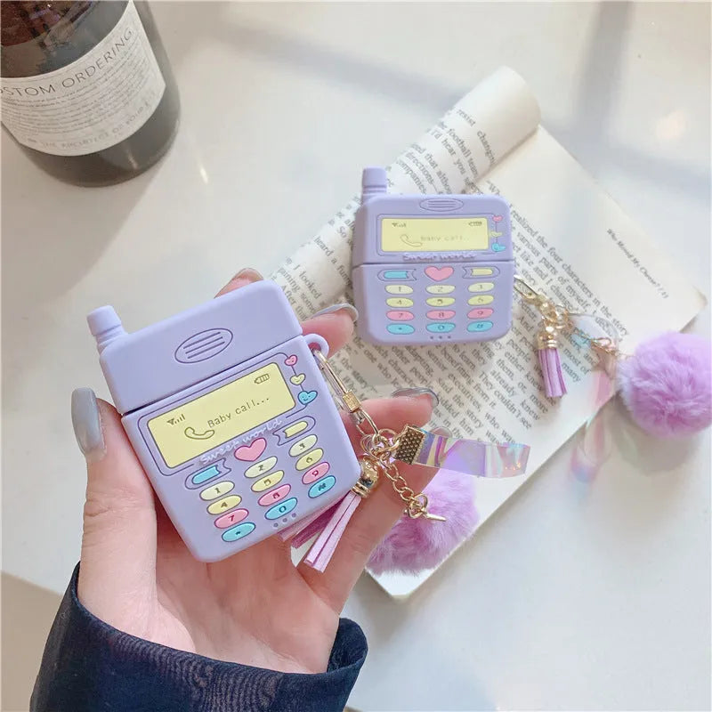 Purple silicone Apple AirPods protective case with fur ball pendant, clamshell design
