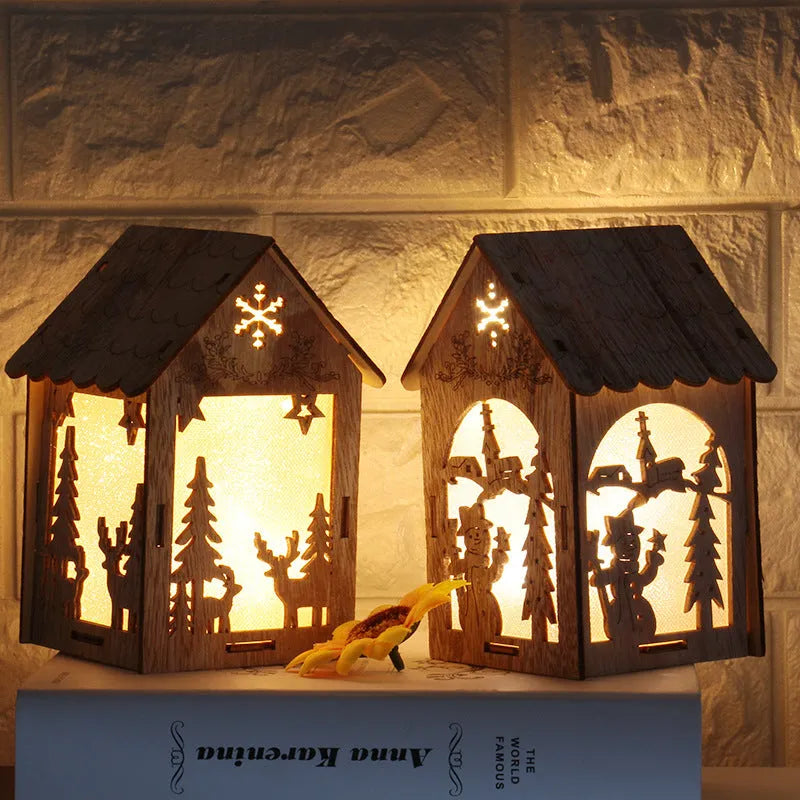 Set of three small wooden Christmas house decorations including a log bell and snowman design on a rustic surface.