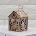 Set of three small wooden Christmas house decorations including a log bell and snowman design on a rustic surface.