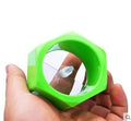Yellow and green plastic spiral vegetable cutter for slicing cucumbers on a kitchen counter.