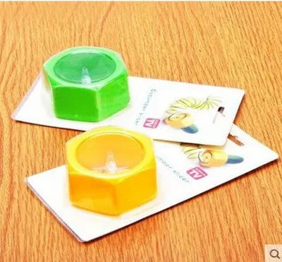 Yellow and green plastic spiral vegetable cutter for slicing cucumbers on a kitchen counter.