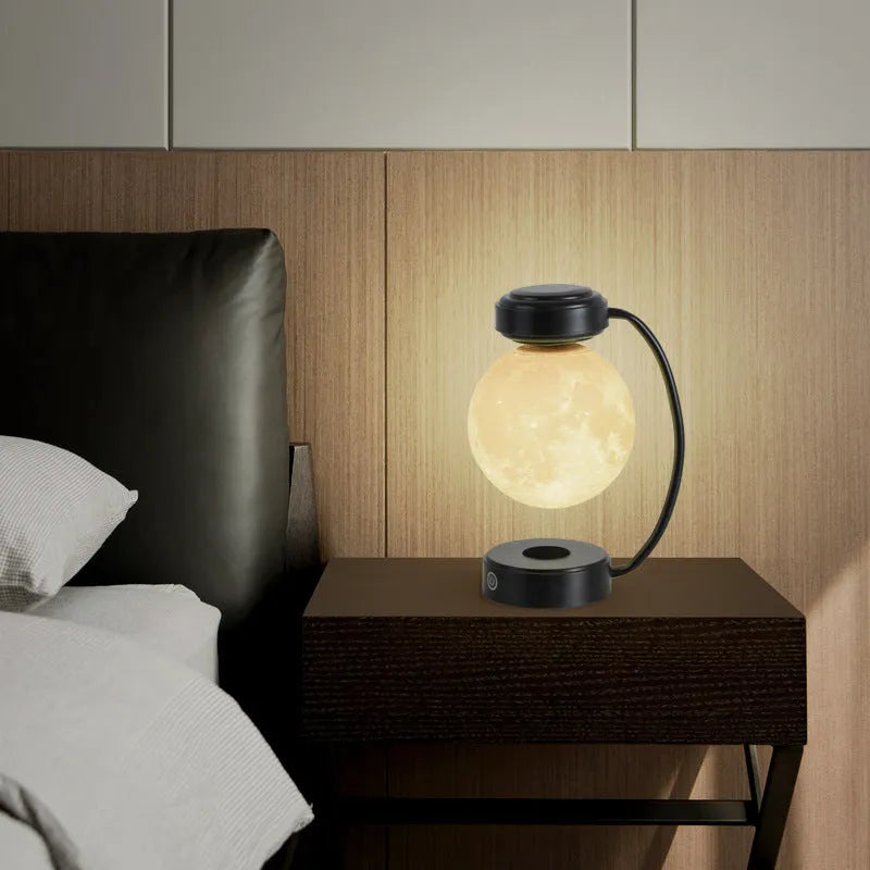 Black magnetic levitation moon lamp floating above base with touch control and colour-changing LED lights