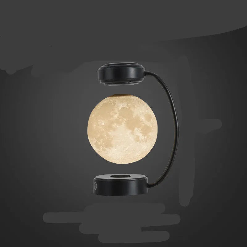 Black magnetic levitation moon lamp floating above base with touch control and colour-changing LED lights