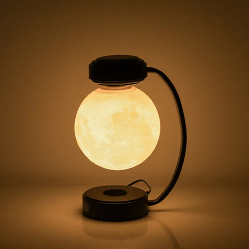 Black magnetic levitation moon lamp floating above base with touch control and colour-changing LED lights