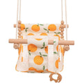 Natural beige cotton canvas baby swing chair with wooden seat and decorative tassel pattern, hanging indoors.