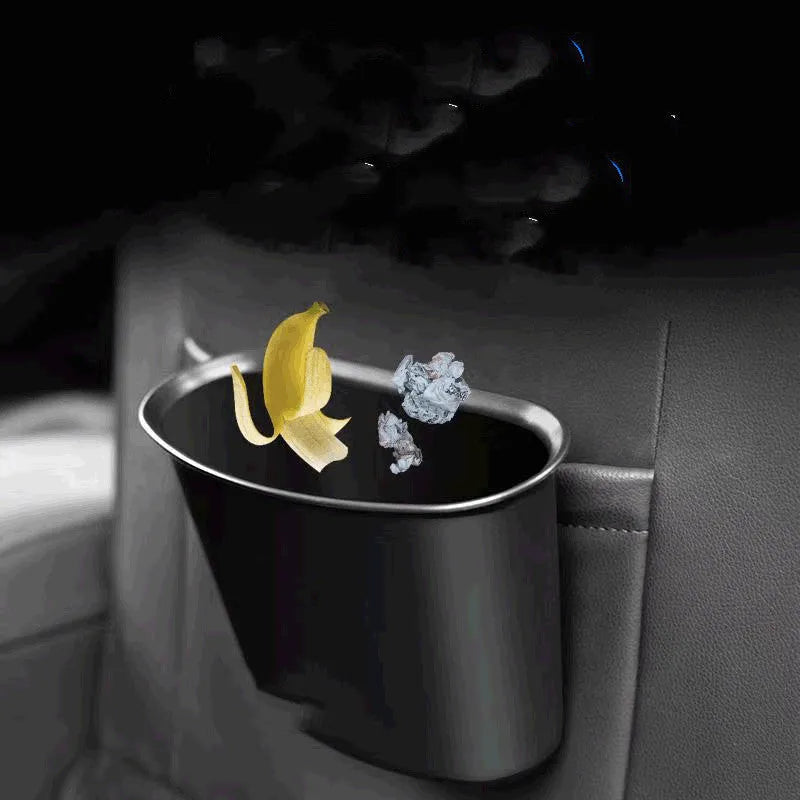 Black universal hanging car storage bucket used as a car trash can inside a vehicle