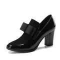 Black patent leather women's high heel shoes with a thick block heel and square toe.
