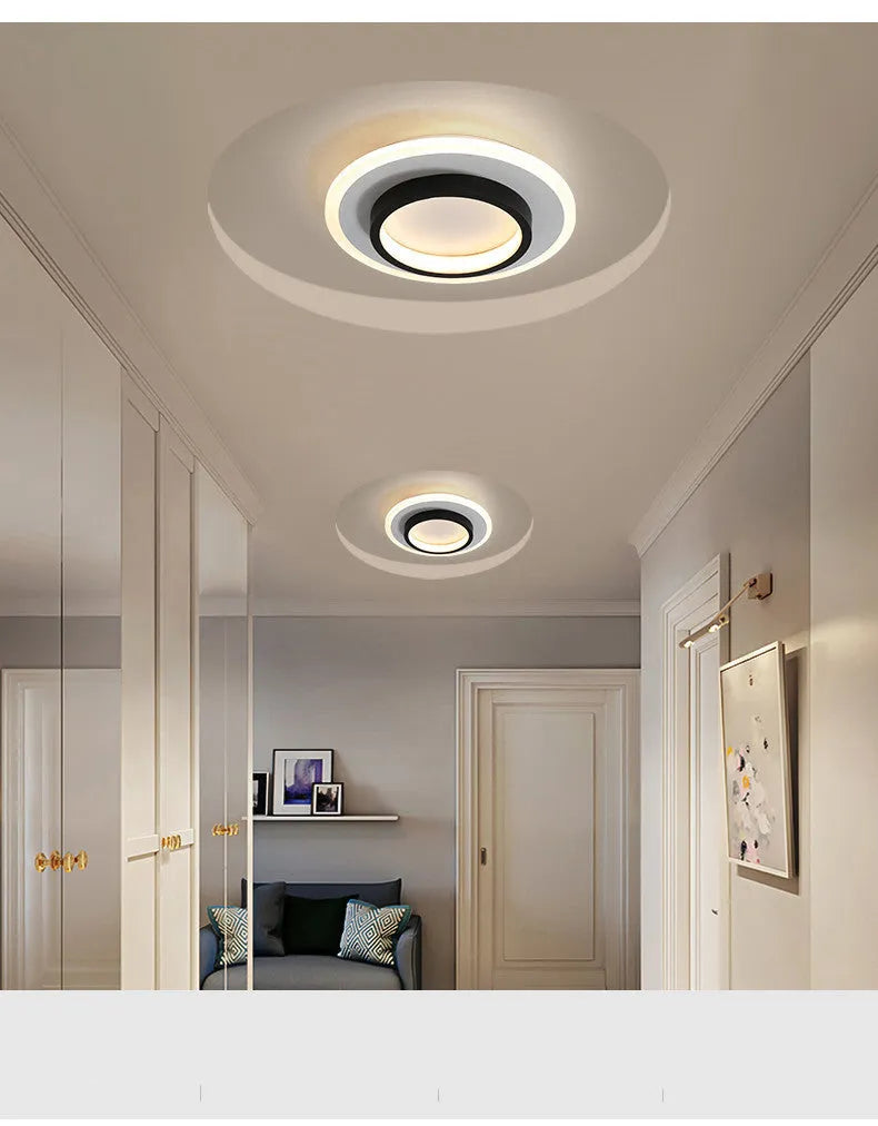 Black circular LED corridor light with aluminium and acrylic construction, 21cm diameter, for balcony or porch use