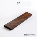 Solid walnut wood wrist rest for mechanical keyboard on a wooden desk