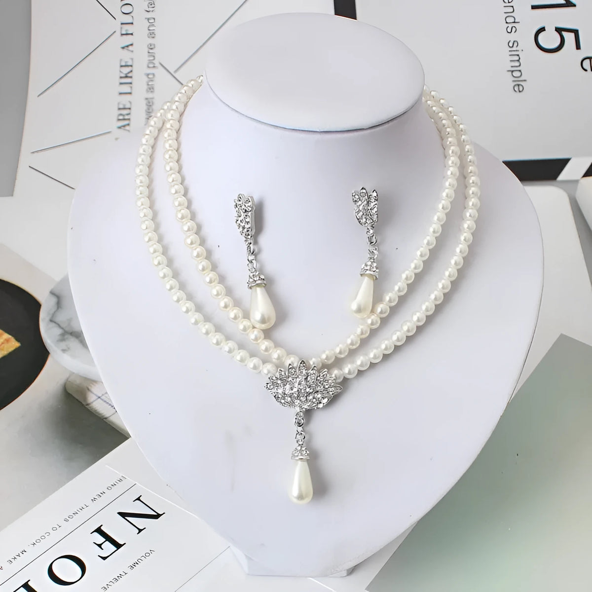 European and American alloy necklace set with pearl and crystal drop pendant and earrings on white background